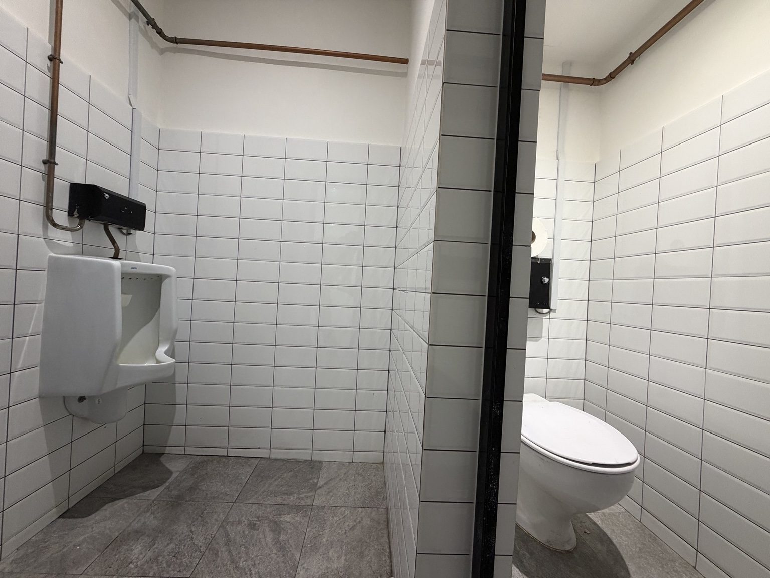 Washroom with urinal and toilet cubicle