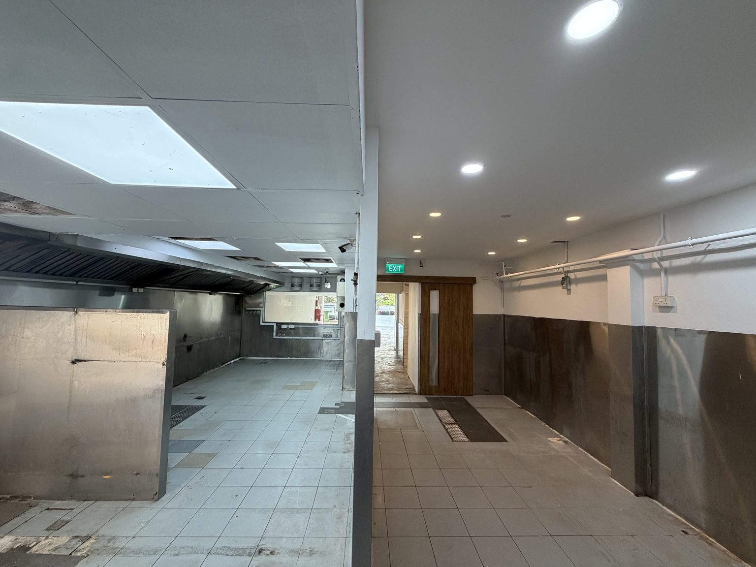 Kitchen divided into cooking and adjoining tiled areas